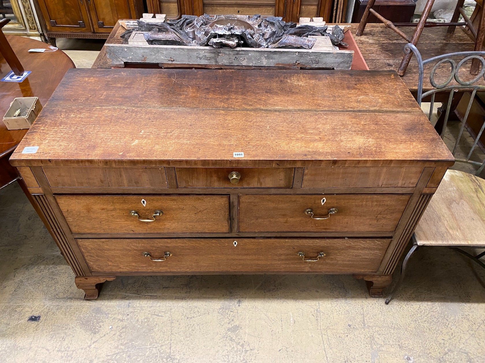 A George III oak and mahogany four drawer low chest, altered, width 133cm, depth 56cm, height 82cm